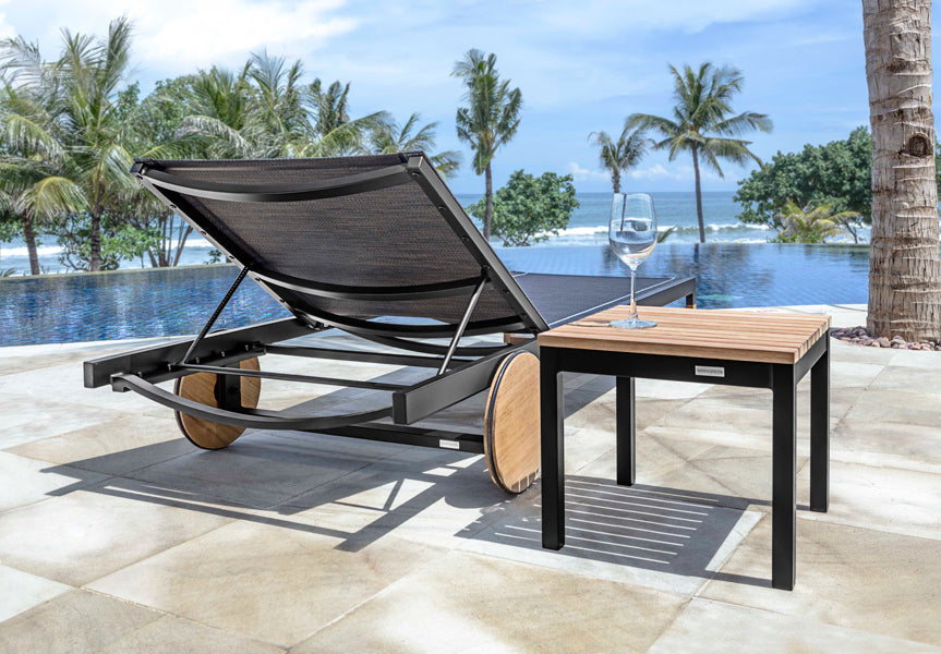 Ekka Lounger by Mamagreen, showing ekka lounger with side table in live shot.
