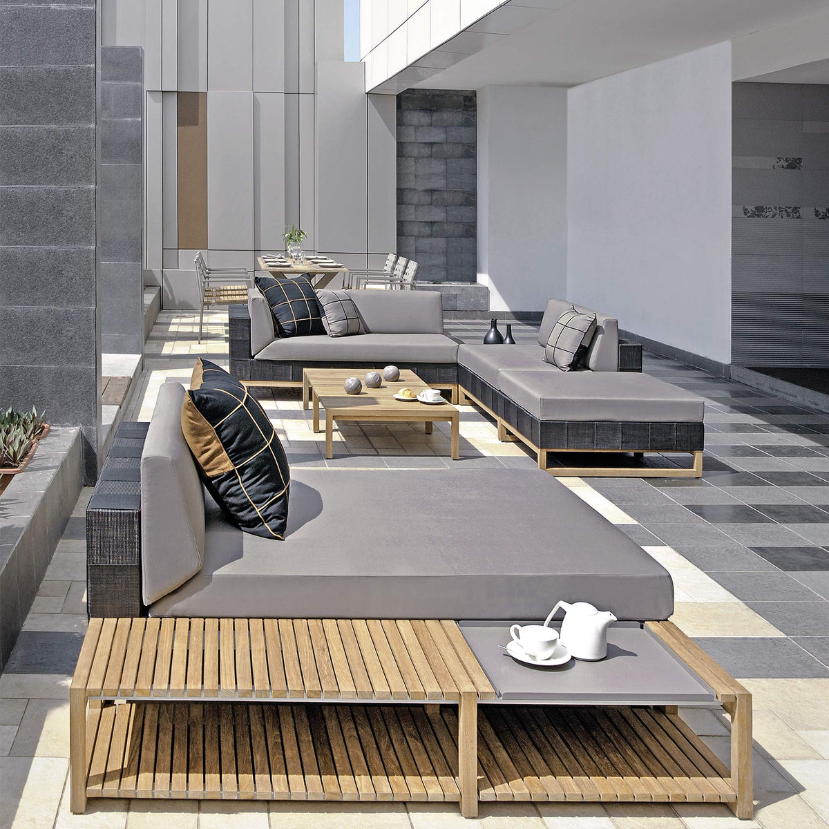 Ekka Ottoman by Mamagreen, showing ekka ottoman with ekka right hand sectional, ekka sectional chaise, ekka sectional seat, ekka long table and ekka sectional coffee table in live shot.