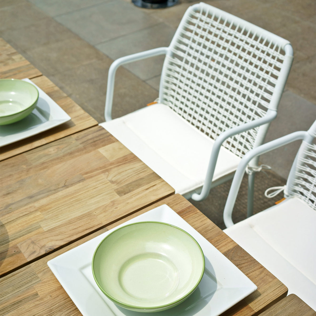 Manda Aluminum Stackable Woven Dining Chair by Mamagreen, showing detail view of manda aluminum stackable woven dining chair in live shot.