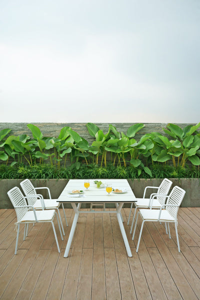 Manda Aluminum Stackable Woven Dining Chair by Mamagreen, showing group of manda aluminum stackable woven dining chair with manda hpl dining table in live shot.