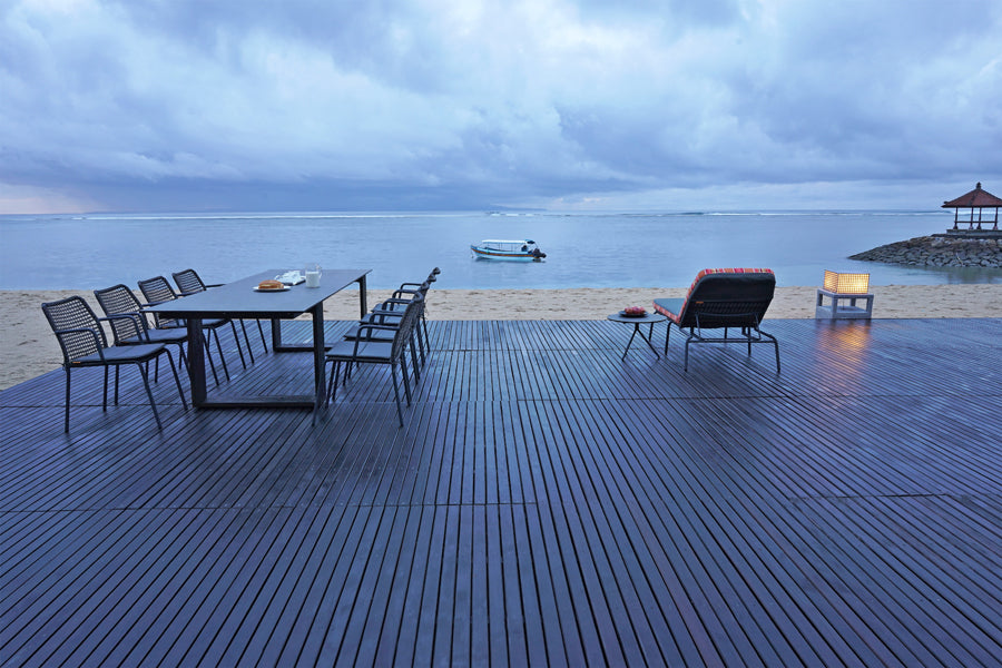 Manda Aluminum Stackable Woven Dining Chair by Mamagreen, showing group of manda aluminum stackable woven dining chair with aiko dining table, bono low table and bono stacking lounger in live shot.