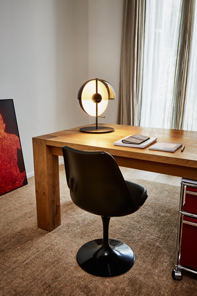 Theia Table Lamp by Marset, showing angle view of white table lamp in live shoot.