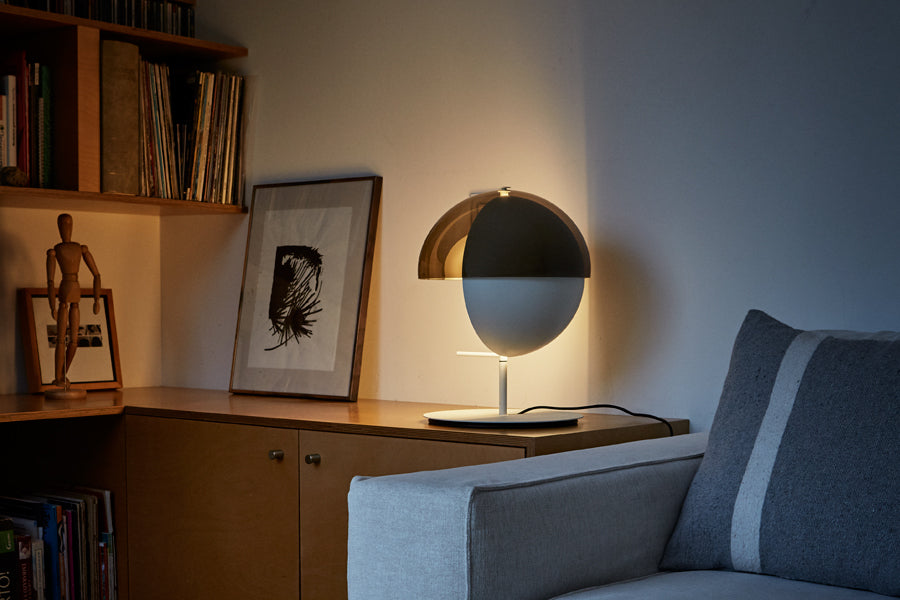 Theia Table Lamp by Marset, showing back view of white table lamp in live shoot.