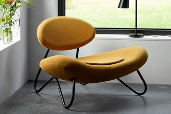 Meadow Lounge Chair by Woud, showing meadow lounge chair in live shot.