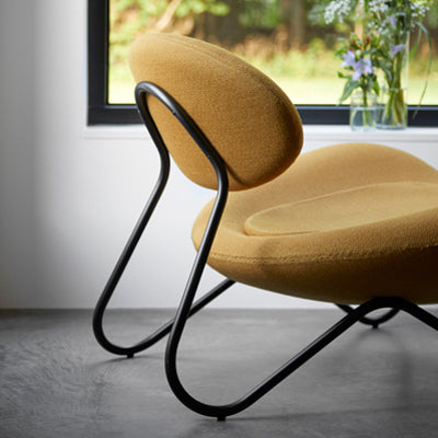 Meadow Lounge Chair by Woud, showing closeup view of meadow lounge chair in live shot.