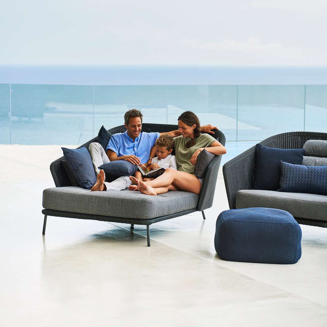 Mega Lounge Chair by Cane-Line, showing side view of mega lounge chair in live shot.
