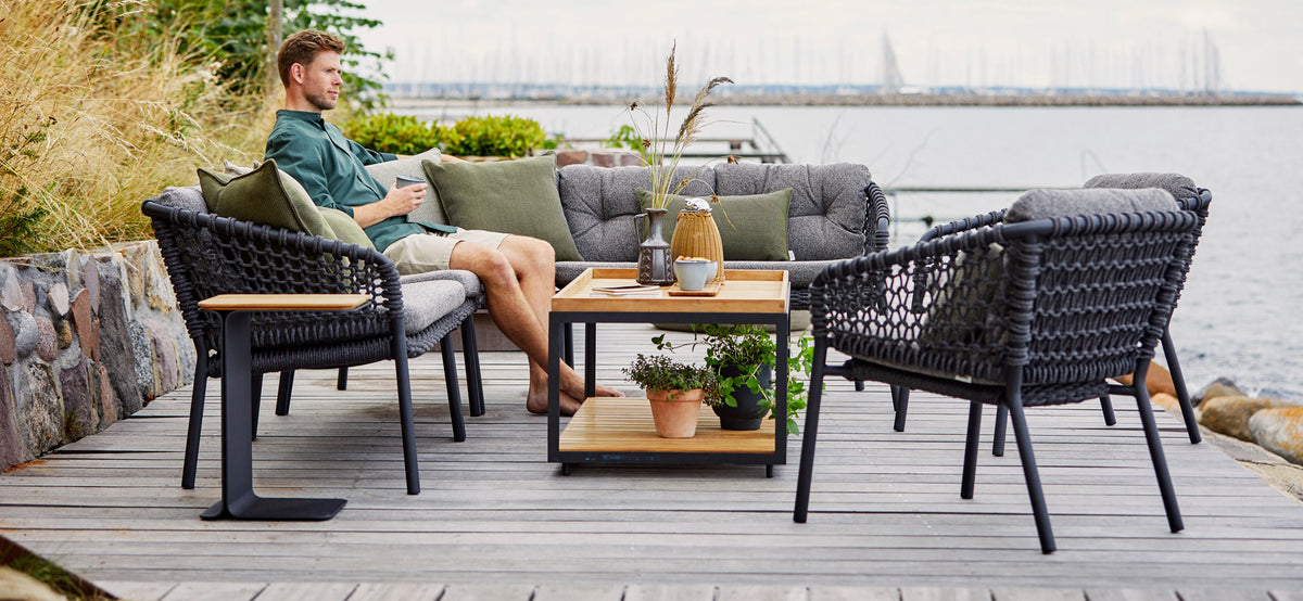 Mega Side Table by Cane-Line, showing mega side table in live shot.
