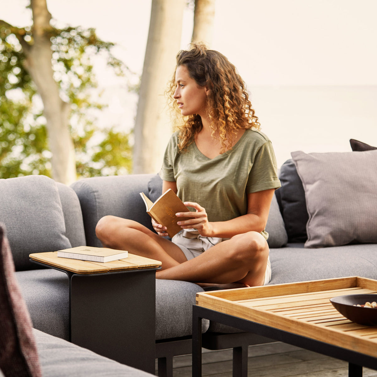 Mega Side Table by Cane-Line, showing mega side table in live shot.