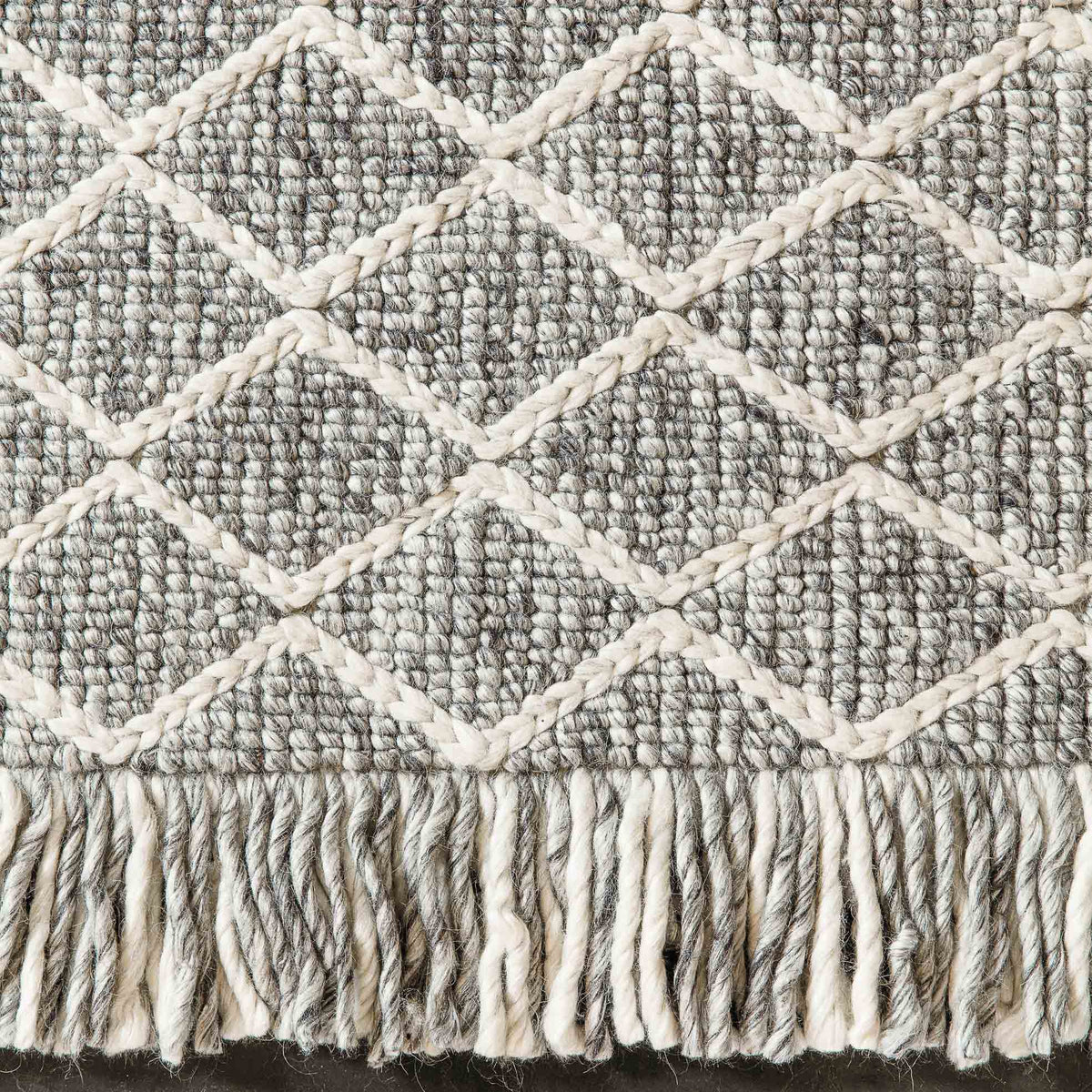 Merge 230.001.900 Hand Woven Rug by Ligne Pure, showing closeup view of merge hand woven rug in live shot.