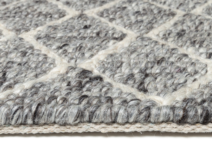 Merge 230.001.900 Hand Woven Rug by Ligne Pure, showing closeup view of merge hand woven rug in live shot.