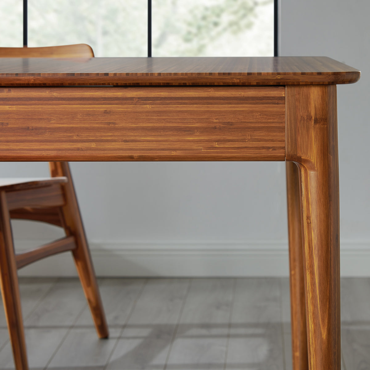 Mija Extensible Dining Table by Greenington, showing closeup view of mija extensible dining table with chair in live shot.