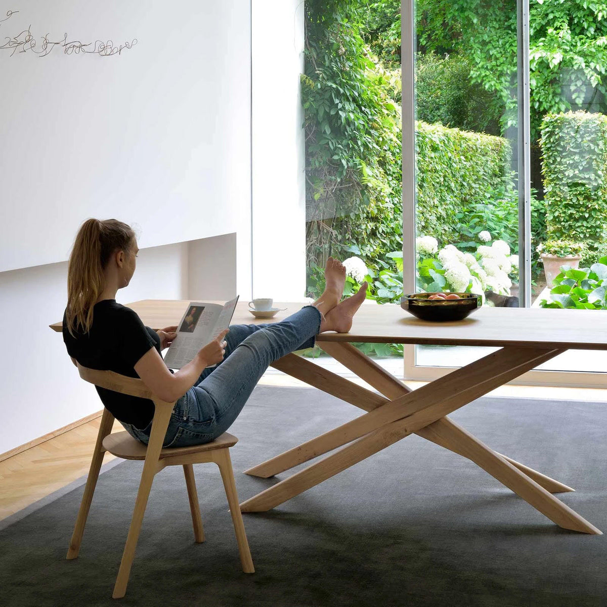 Mikado Dining Table by Ethnicraft, showing mikado dining table in live shot.