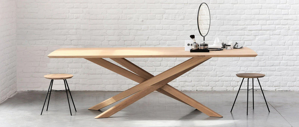 Mikado Dining Table by Ethnicraft, showing mikado oak dining table in live shot.