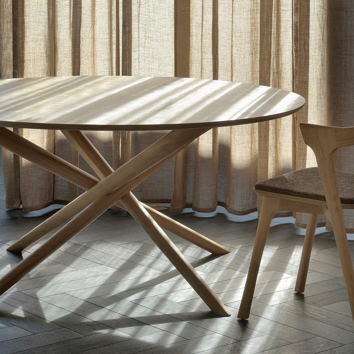 Mikado Dining Table by Ethnicraft, showing mikado oak dining table in live shot.