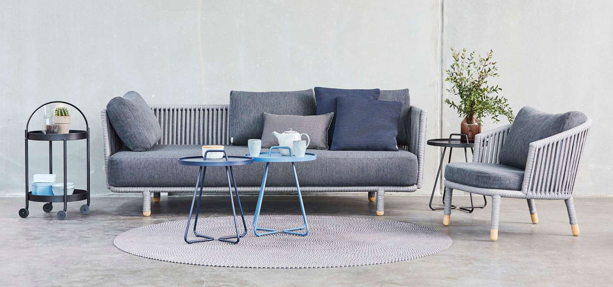Moments Indoor 3-Seater Sofa by Cane-Line, showing moments indoor 3-seater sofa with chair & tables in live shot.
