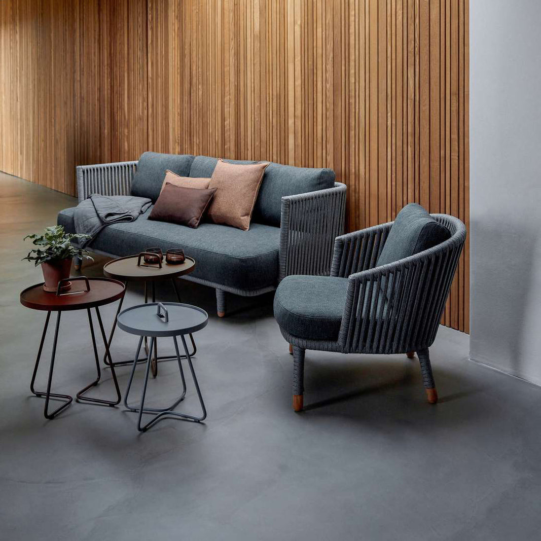 Moments Indoor 3-Seater Sofa by Cane-Line, showing moments indoor 3-seater sofa with chair & tables in live shot.