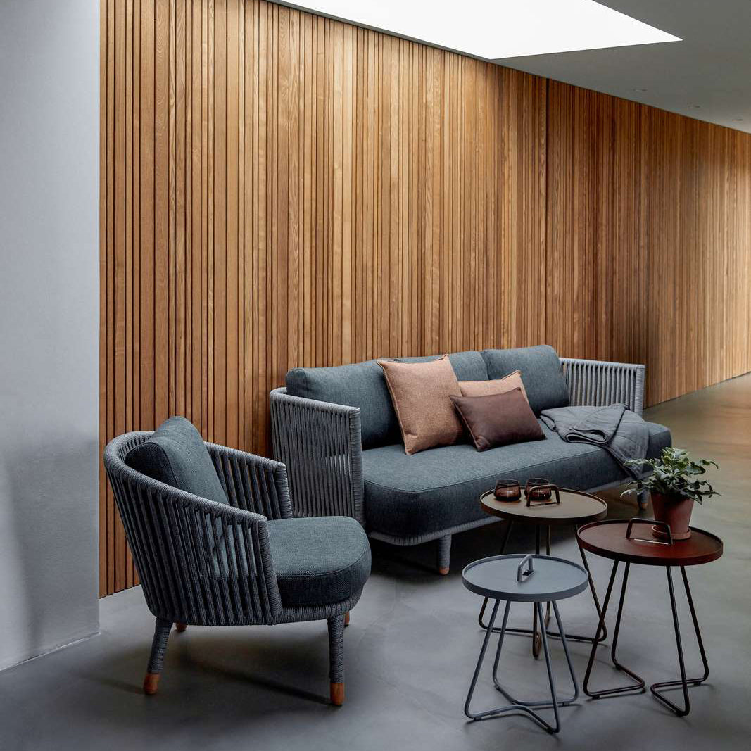 Moments Indoor Lounge Chair by Cane-Line, showing moments indoor lounge chair with sofa in live shot.