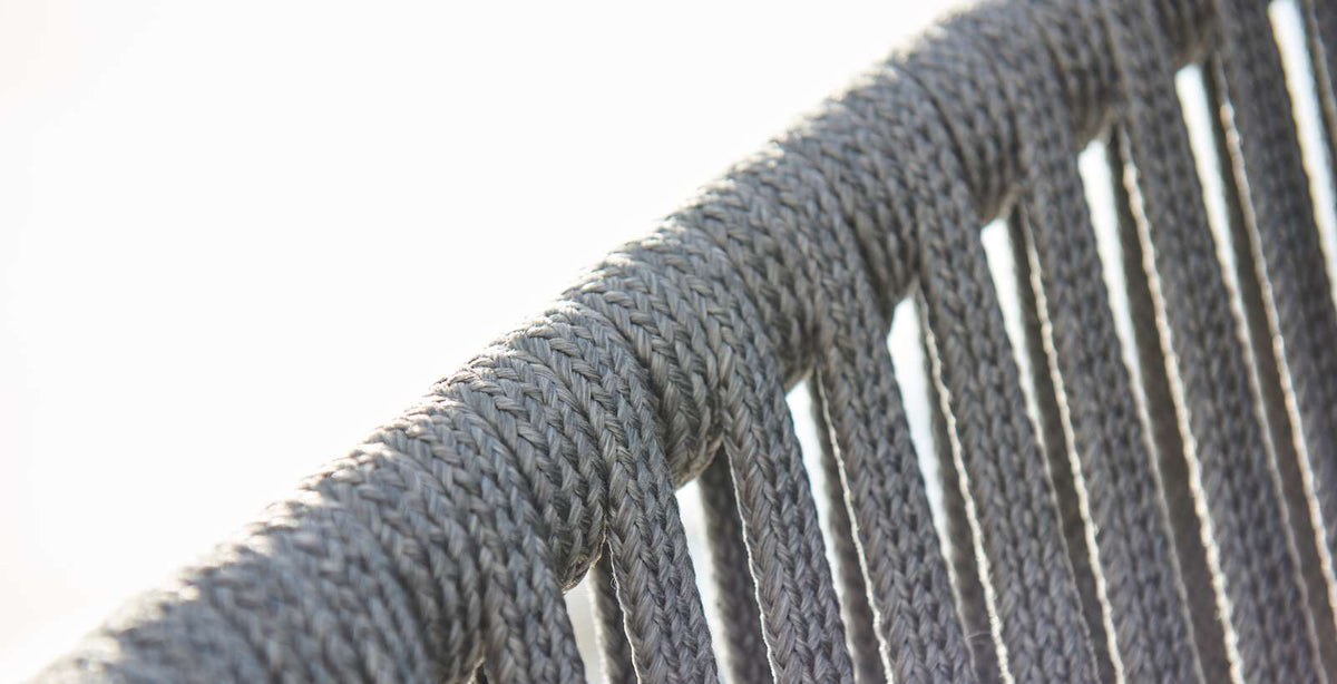 Moments Outdoor Dining Bench by Cane-Line, showing closeup view of moments outdoor dining bench in light grey soft rope.