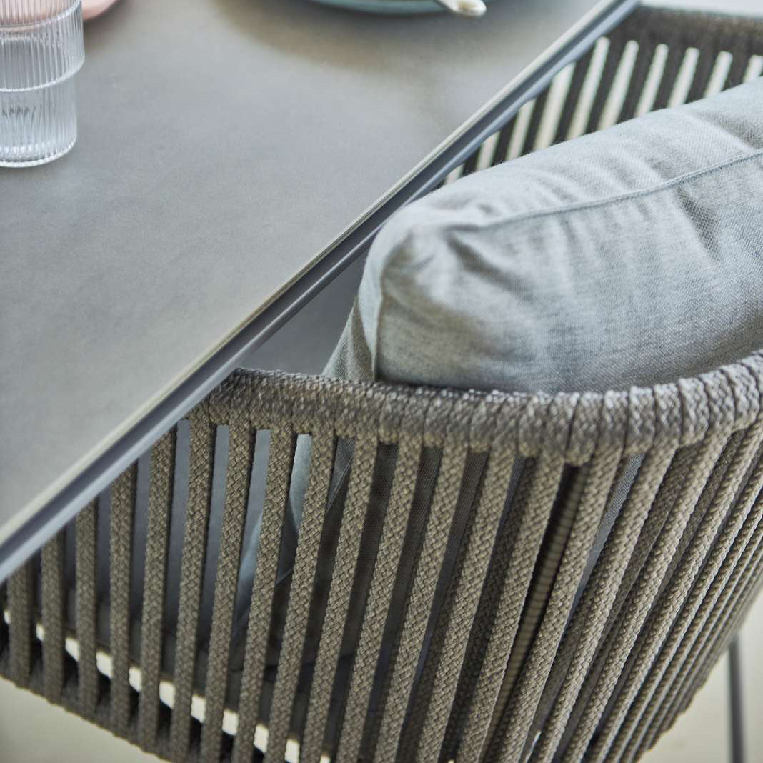Moments Stackable Dining Armchair by Cane-Line, showing moments stackable dining armchair in live shot.