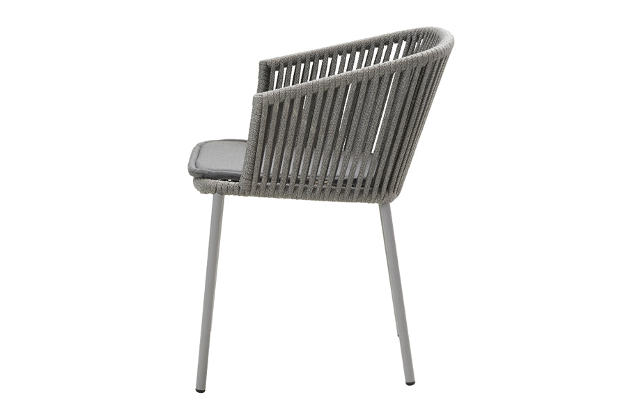 Moments Stackable Dining Armchair by Cane-Line, showing side view of moments stackable dining armchair in grey soft rope/grey natte cushion.