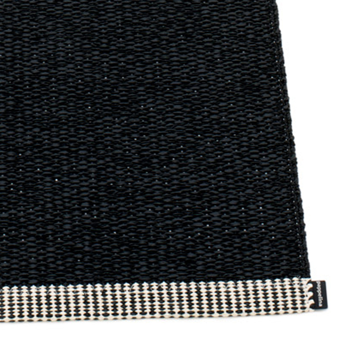Mono Black Rug by Pappelina, showing closeup view of mono black rug.