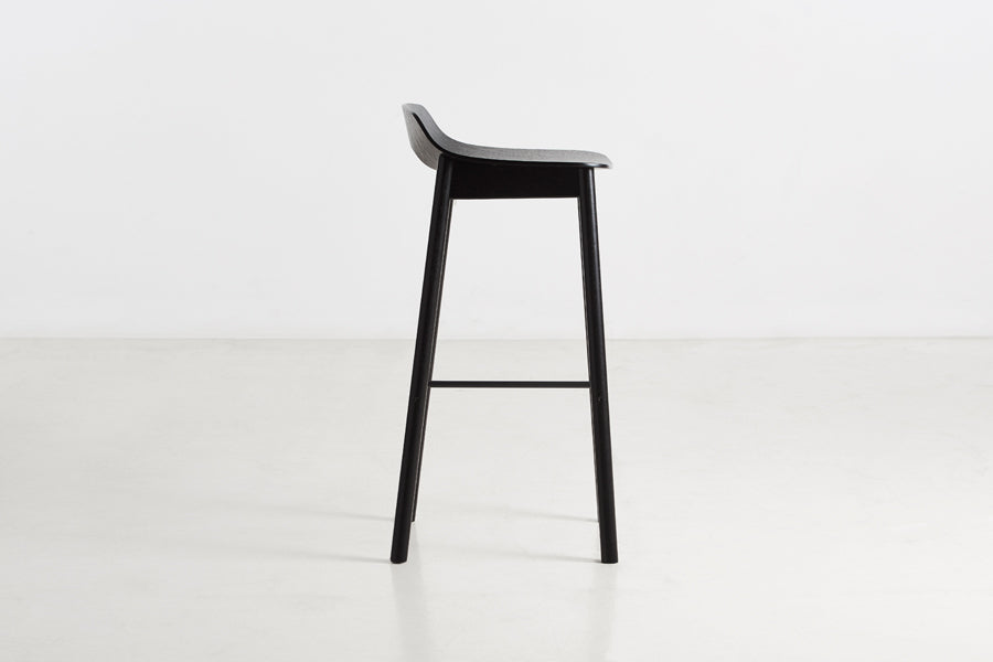 Mono Stool/Chair by Woud, showing side view of mono stool/chair in studio shot.
