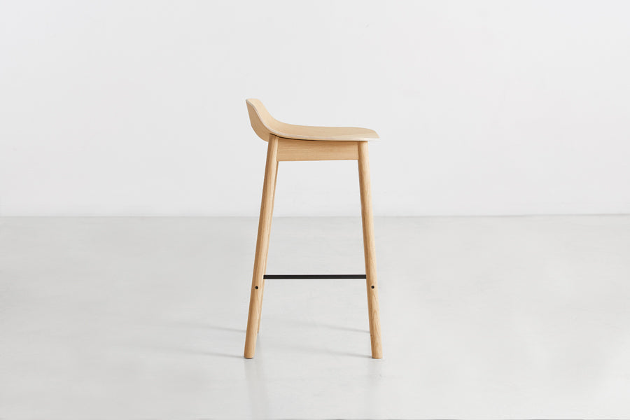 Mono Stool/Chair by Woud, showing side view of mono stool/chair in studio shot.