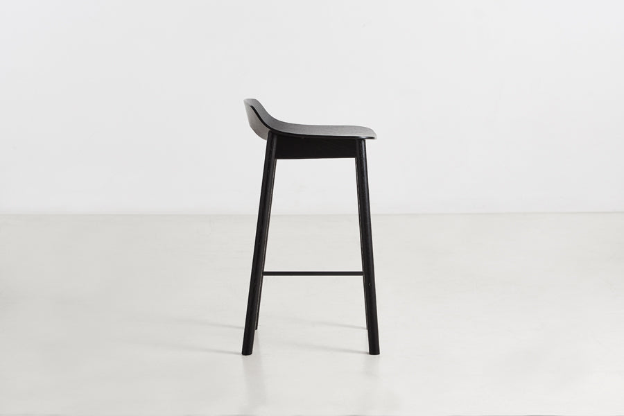 Mono Stool/Chair by Woud, showing side view of mono stool/chair in studio shot.