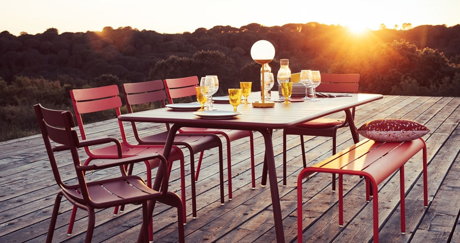 Mooon Lamps by Fermob, showing lamp, table, chairs & bench in live shot.