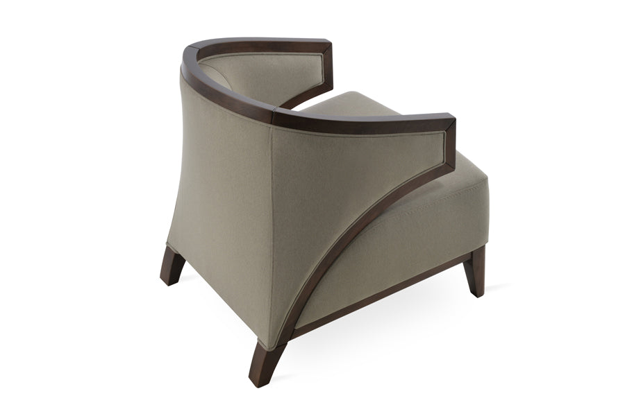 Mostar Arm Chair by SohoConcept, showing back angle view of arm chair with table.