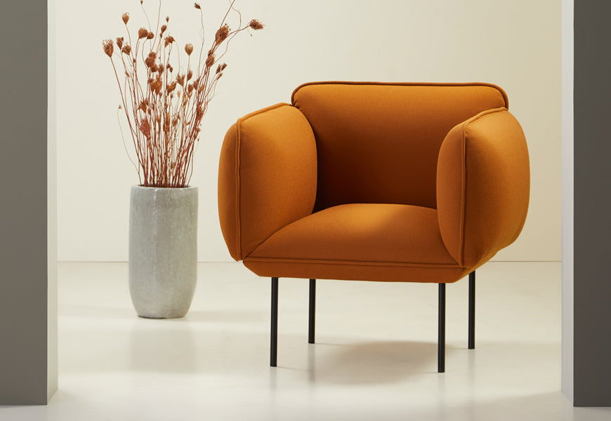 Nakki Armchair by Woud, showing nakki armchair in live shot.