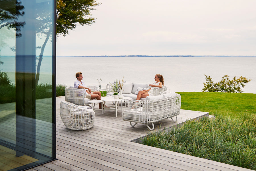 Nest Outdoor Sofa by Cane-Line, showing nest outdoor sofa in the live shot.