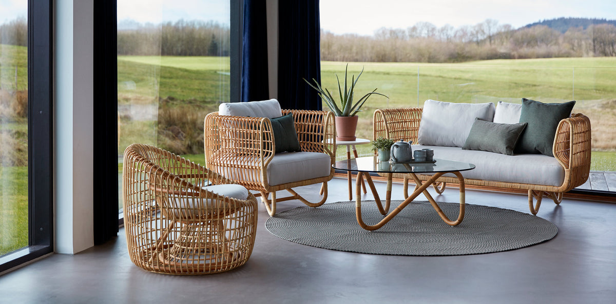 Nest Indoor Sofa by Cane-Line, showing nest indoor sofa with chairs & table in live shot.