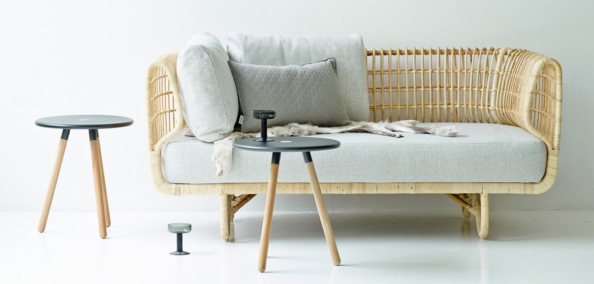 Nest Indoor Sofa by Cane-Line, showing nest indoor sofa with tables in live shot.