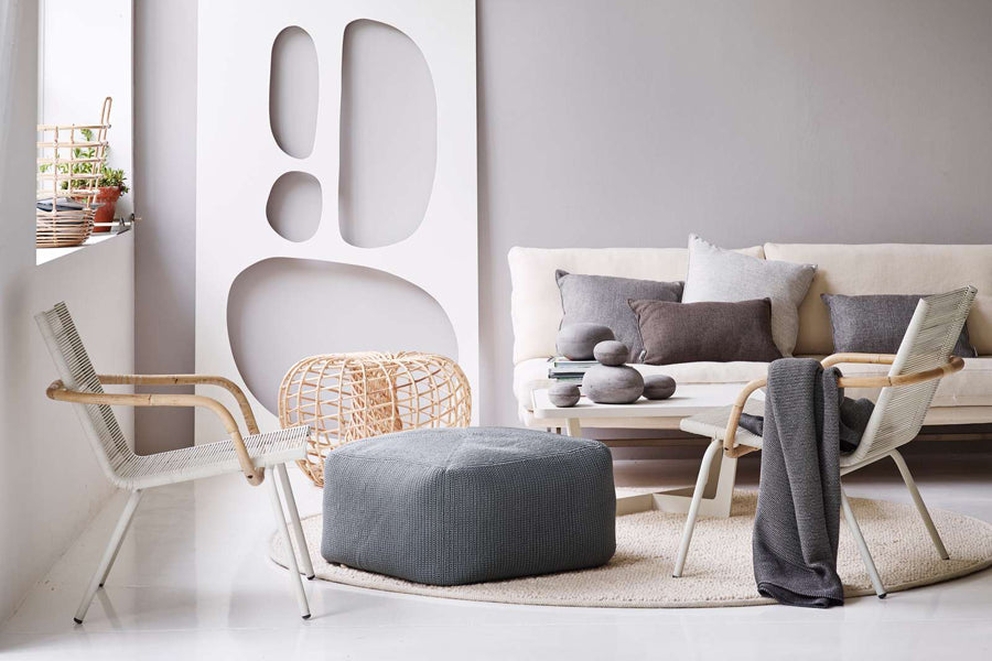 Nest Indoor Coffee Table/Footstool by Cane-Line, showing nest indoor coffee table/footstool in live shot.