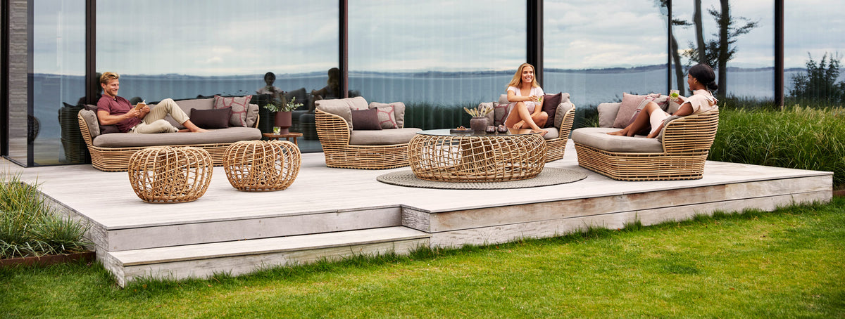 Nest Outdoor Footstool/Coffee Table by Cane-Line, showing nest outdoor footstool/coffee table in live shot.