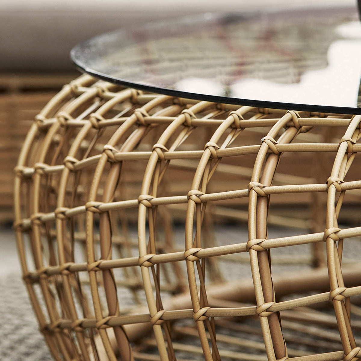 Nest Outdoor Footstool/Coffee Table by Cane-Line, showing closeup view of nest outdoor footstool/coffee table in live shot.
