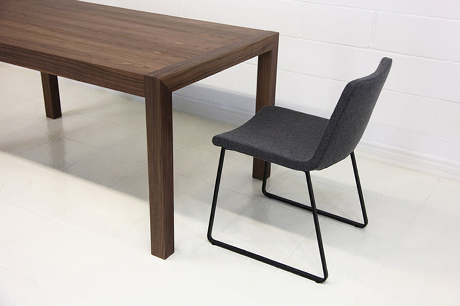 Nevada Sled Dining Chair by SohoConcept, shown in light grey wool with black powder coated steel tubes base.