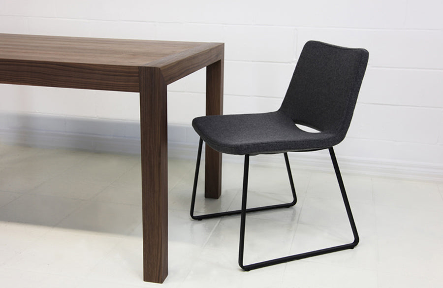 Nevada Sled Dining Chair by SohoConcept, shown in light grey wool with black powder coated steel tubes base.