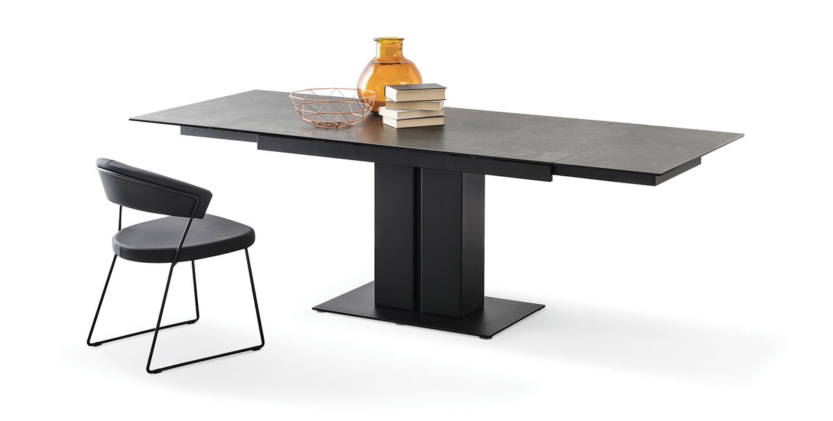 New York Chair by Connubia, showing back view of new york chair in matt black metal frame + black soft leather seat with table.