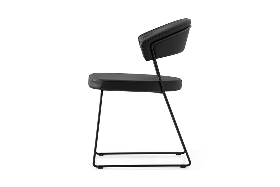 New York Chair by Connubia, showing side view of new york chair in matt black metal frame + black soft leather seat.