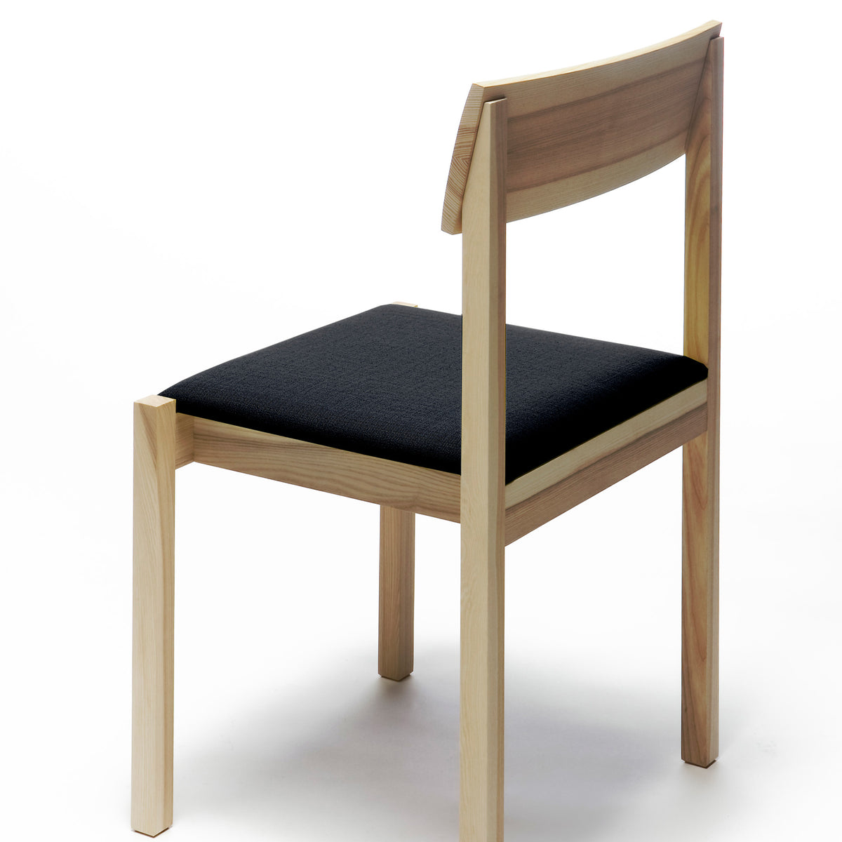 Arkitecture KVT7 Chair by Nikari, showing backside view of arkitecture kvt7 chair in ash, fabric 2: steelcut trio by kvadrat.
