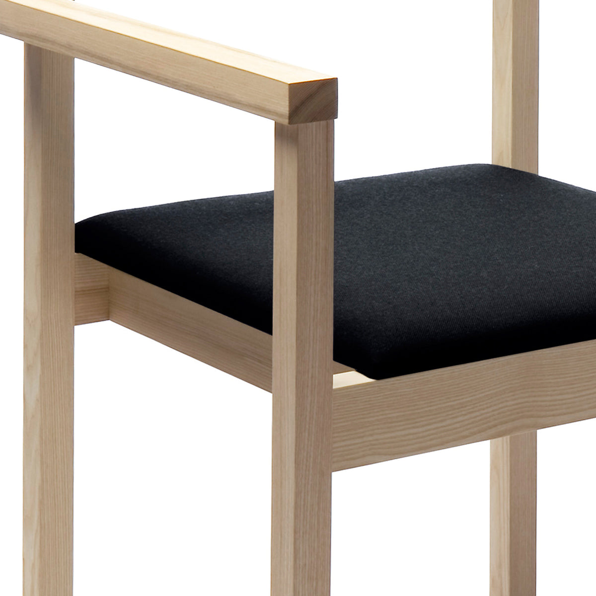 Arkitecture KVT8 Chair with Armrests by Nikari, showing detail view of seat of arkitecture kvt8 chair with armrests in ash, fabric 2: steelcut trio by kvadrat.