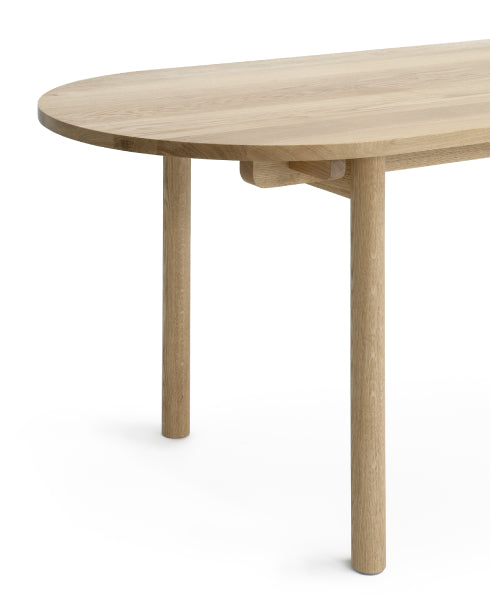 Basic Table by Nikari, showing detail view of oval end of basic table in oak.