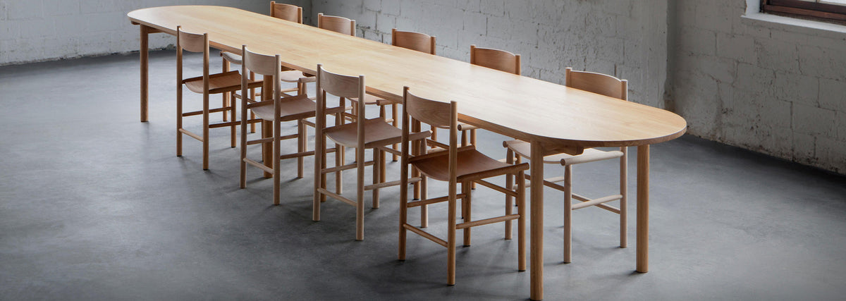 Linea Akademia Dining Chair by Nikari, showing linea akademia dining chairs with dining table in live shot.