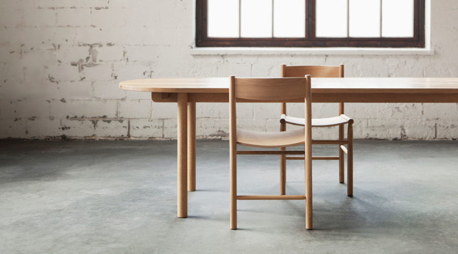 Linea Akademia Dining Chair by Nikari, showing linea akademia dining chairs with table in live shot.