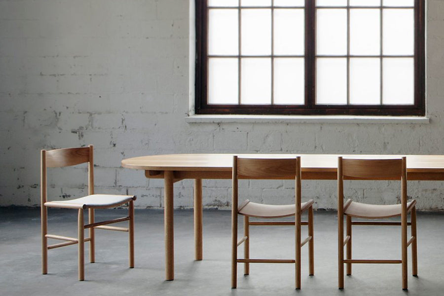 Linea Akademia Dining Chair by Nikari, showing linea akademia dining chairs with table in live shot.