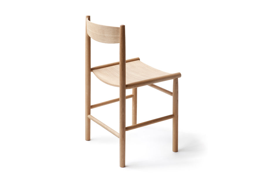 Linea Akademia Dining Chair by Nikari, showing back side view of linea akademia dining chair in lacquer oak, no upholstery.