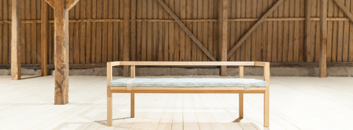 Storia Konstruktio Bench by Nikari, showing storia konstruktio bench with seat pad in live shot.