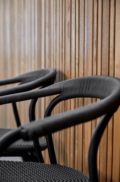 Noble Indoor Armchair by Cane-Line, showing closeup view of noble indoor armchairs in live shot.